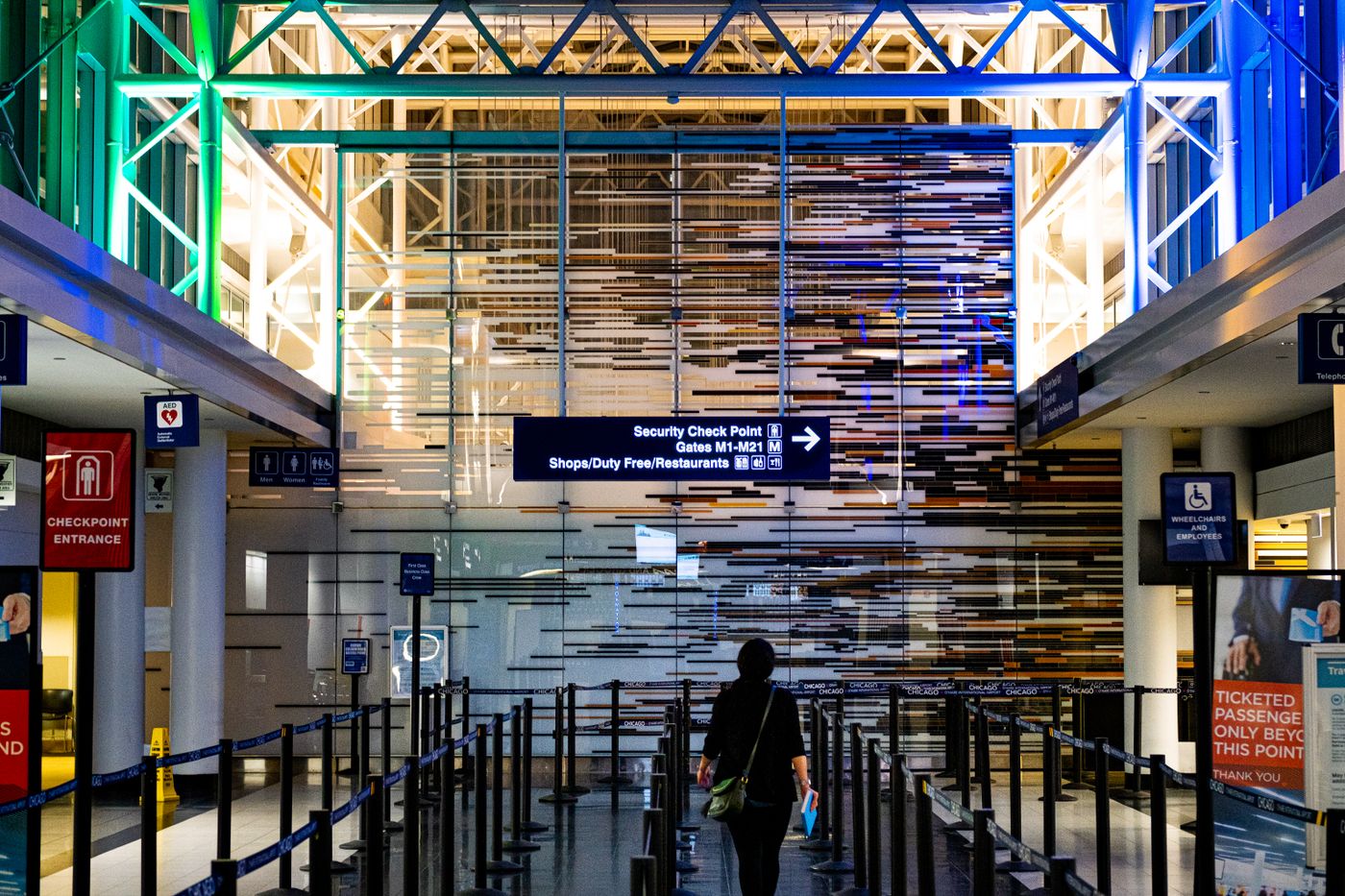 A traveller walks towards an empty security checkpoint at O'Hare Airport